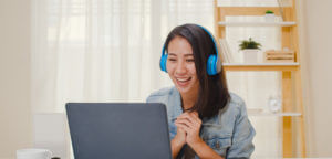 Student wearing headphones, looking at computer screen