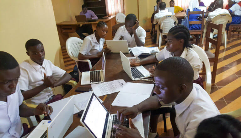 Students working on laptops at Liberia Career Pathways