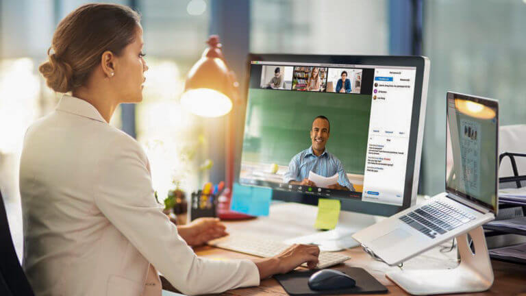 An adult participating in a video conference meeting