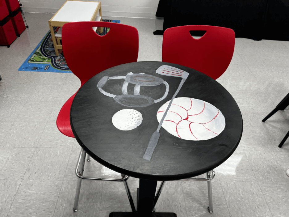 Steamer Suite tables, handcrafted by students in the construction pathway and uniquely designed and painted by students in the arts and communication pathway.